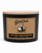 Gooey Duck Candle Co. candle with a wooden lid on a white background