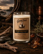 Gooey Duck Candle Co. candle with label on a rustic background
