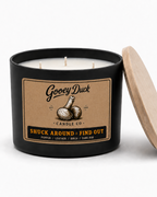 Gooey Duck candle with a wooden lid on a white background