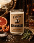 Gooey Duck candle with a label on a wooden surface with decorative items.