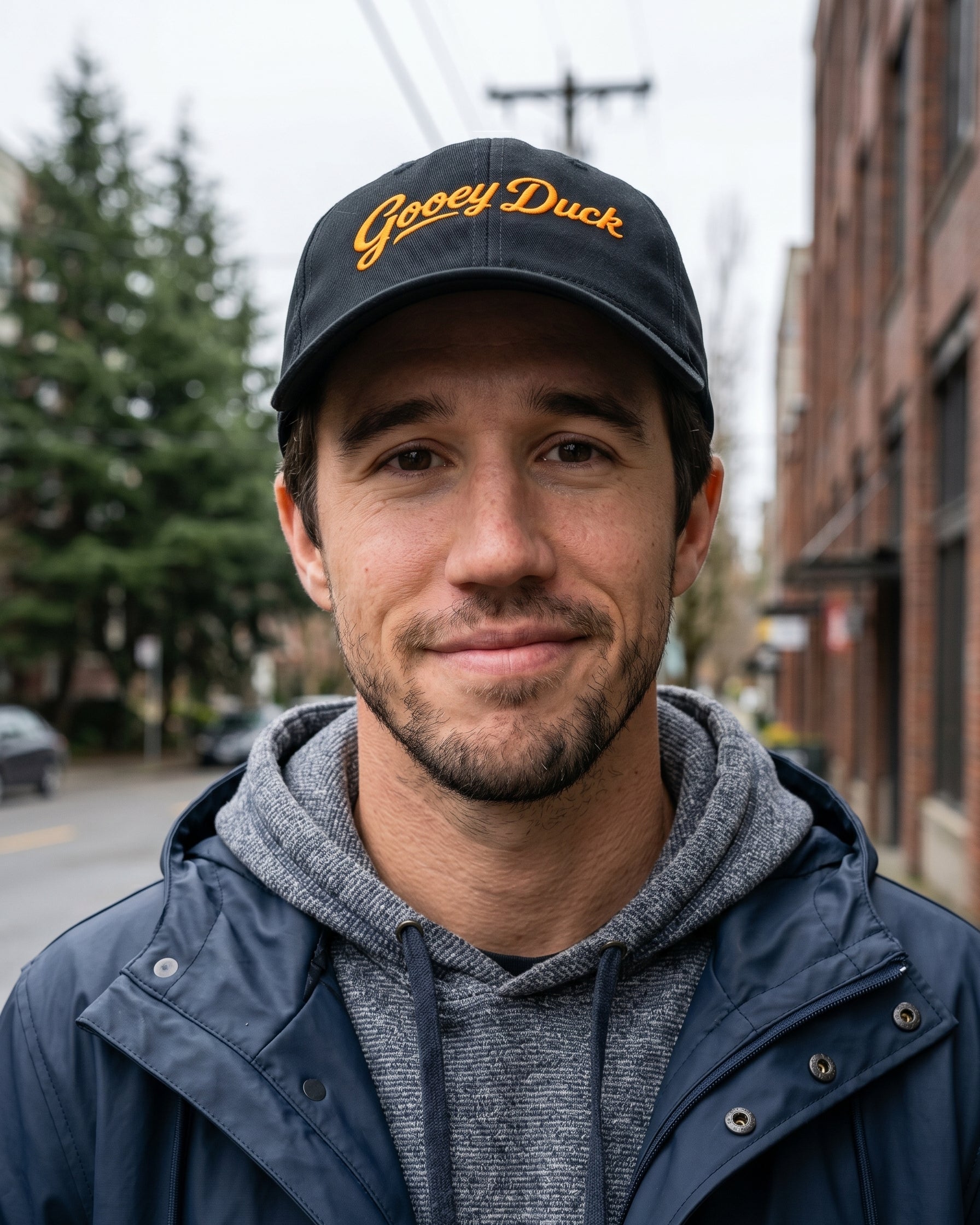 Model wearing black Gooey Duck Logo Cap