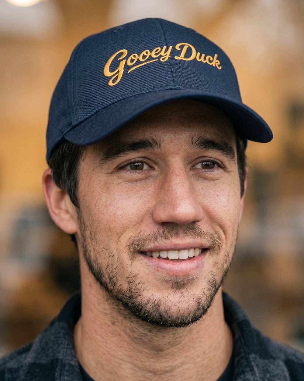 Model wearing true navy Gooey Duck Logo Cap