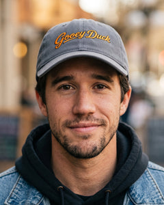 Model wearing charcoal Gooey Duck Logo Cap